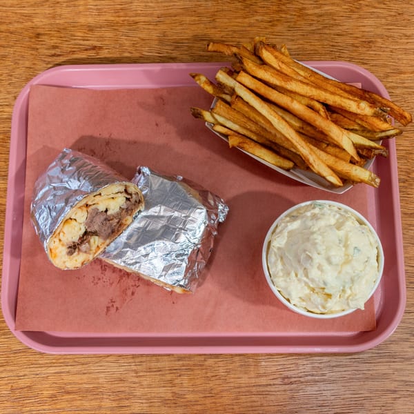 B&B BBQ burrito with mac and cheese, fries, and potato salad on a pink tray.